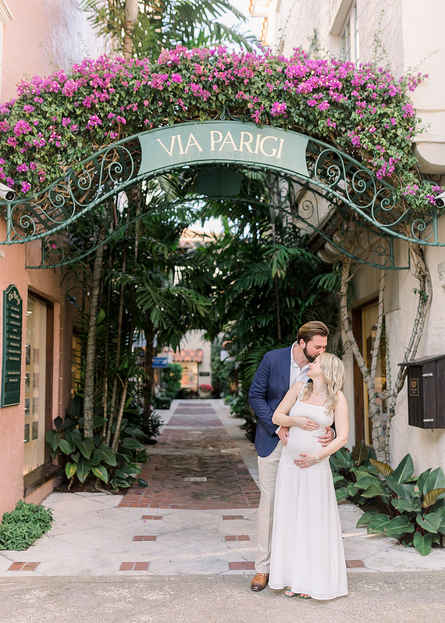 A couple posing for a fine art maternity session at Worth Avenue FL